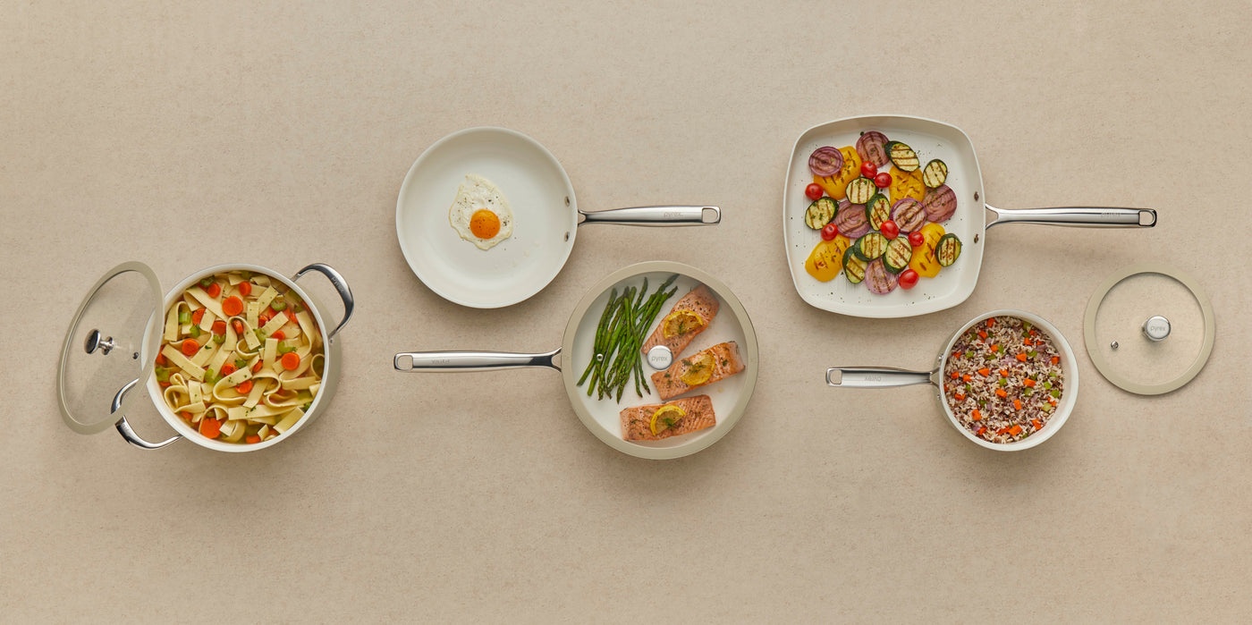Set of cookware with food on a beige background