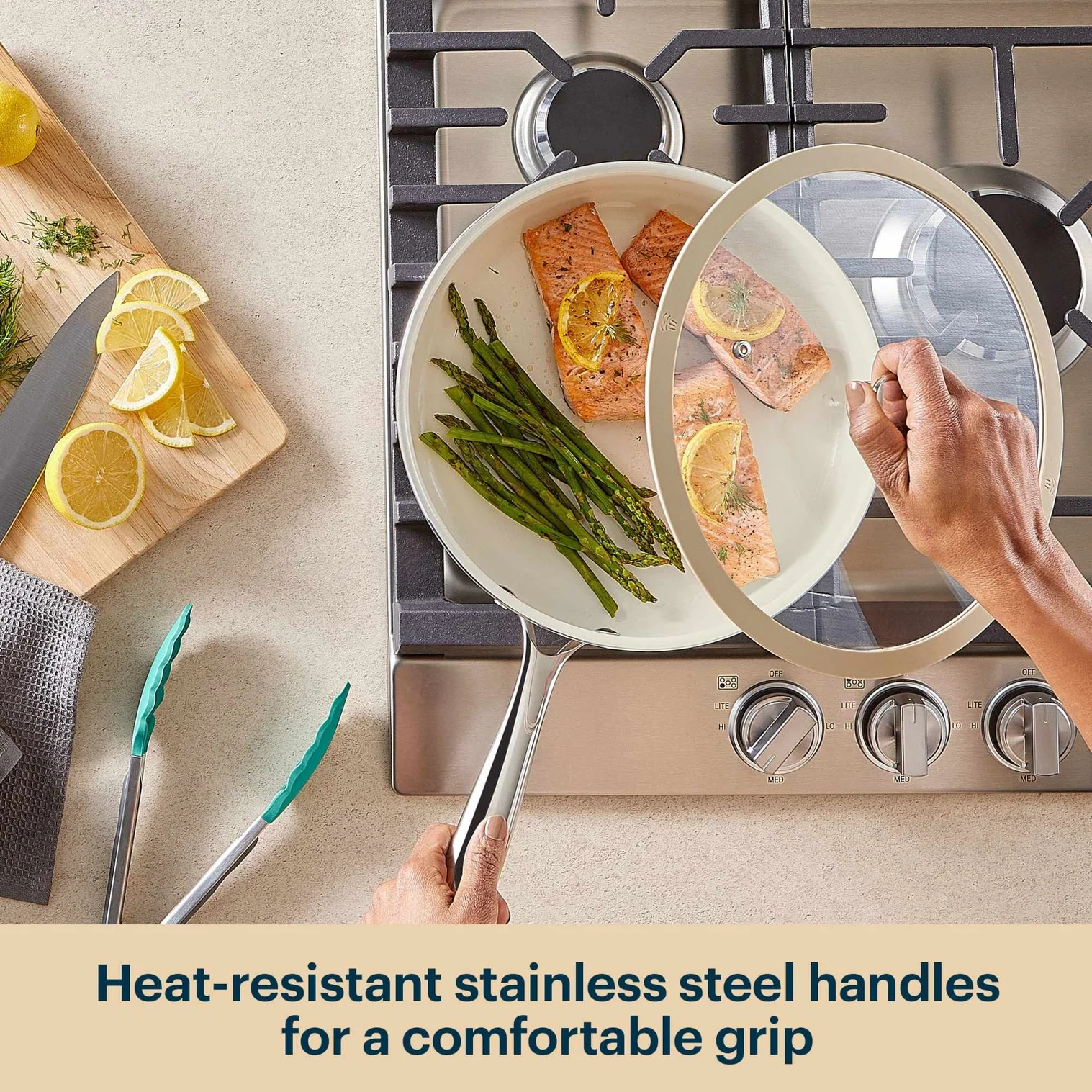 Person holding a pan with food on a stove, with text about heat-resistant stainless steel handles.