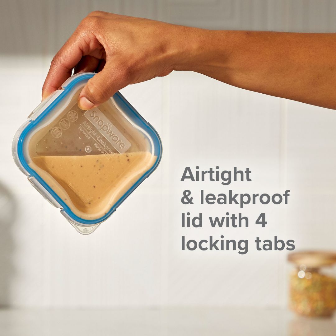 Hand holding a food container with an airtight lid, text indicating features.