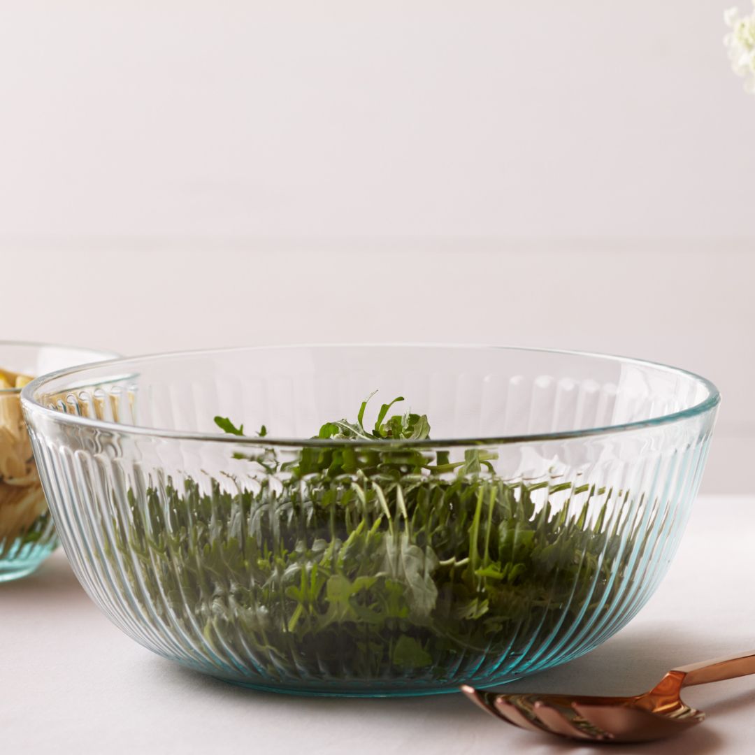 Mixing bowl with salad on a table with a salad spoon